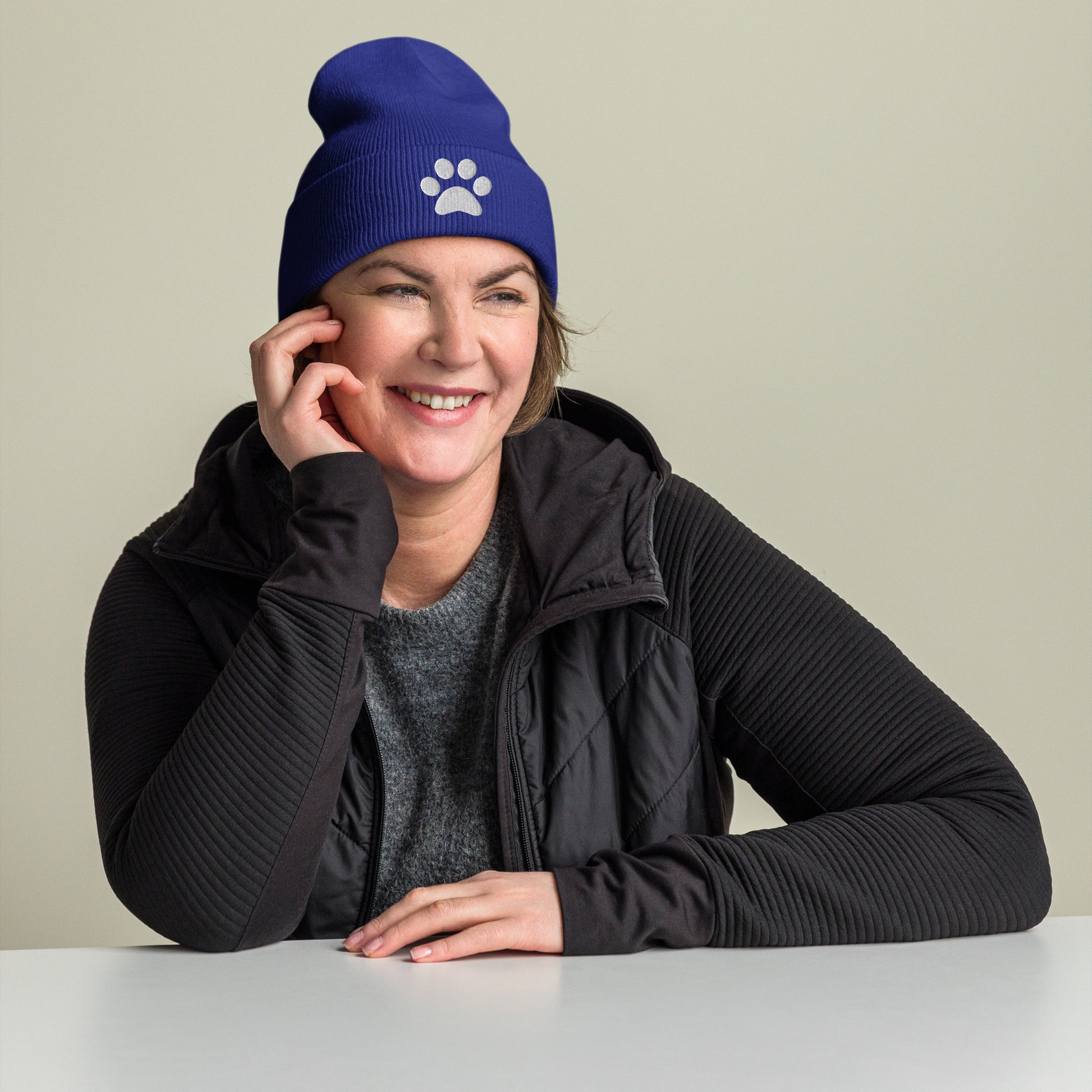 Model wearing Paw Beanie hat for German Shepherd lovers and owners, royal blue color - GSD Colony